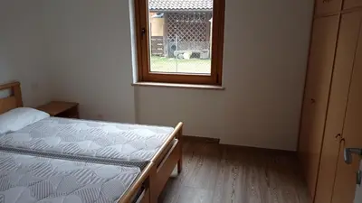 a bedroom with a bed and a window at Casa Dolomite in Mezzano