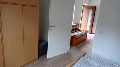a room with a closet and a bedroom with a bed at Casa Dolomite in Mezzano
