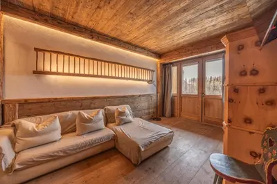 a living room with a couch and a window at Casa Aquila, con sauna privata in Chiave