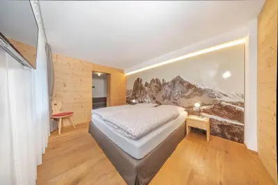 a bathroom with a sink and a toilet and a shower at Garni Tramans in Selva di Val Gardena