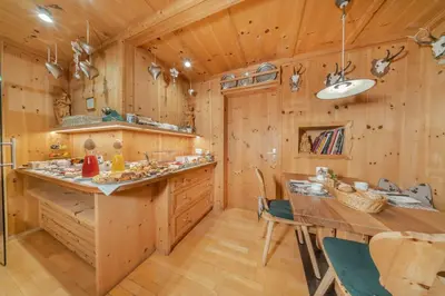 a bedroom with a large bed and a couch at Garni Tramans in Selva di Val Gardena