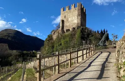 a castle on top of a hill with a fence at El Me Popo in Segonzano