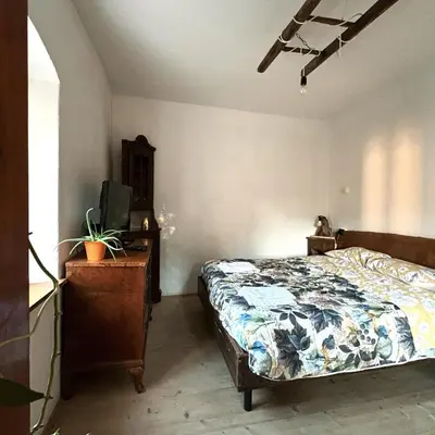 a bedroom with a bed and a desk with a tv at El Me Popo in Segonzano