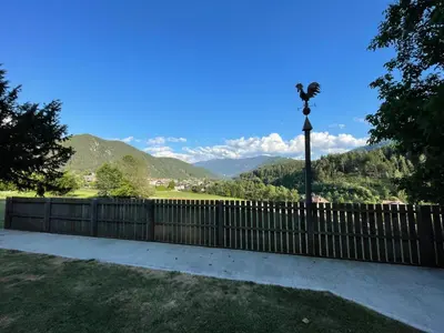 a fence with a light pole and mountains in the background at Gatscherhof Retreat - Family Appartement in Chienes