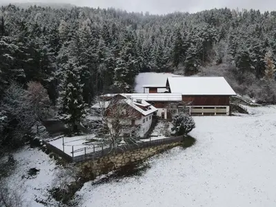 an aerial view of a house in the snow at Gatscherhof Retreat - Family Appartement in Chienes