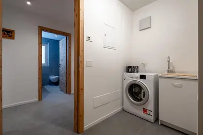 a laundry room with a washer and dryer at Cèsa Cercenà in Canazei