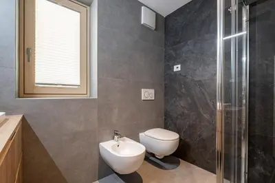 a bathroom with a toilet and a sink and a shower at Cèsa Cercenà in Canazei