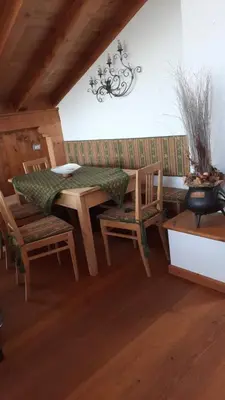 a dining room with a table and chairs in a room at Casa Falco in Cortina dʼAmpezzo