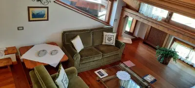 a living room with a couch and a table at Casa Falco in Cortina dʼAmpezzo