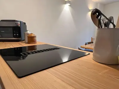 a laptop computer sitting on top of a wooden table at Ciasa dei Pomi Apartment in Sfruz