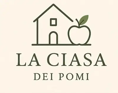 a house and an apple with the words la clasia del point at Ciasa dei Pomi Apartment in Sfruz