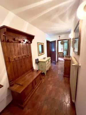 a hallway with a wooden bench in a room at Ca' Virginia - Val di Fassa in Vigo di Fassa