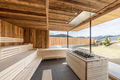 an outdoor sauna with wooden walls and windows at Hotel Rommisa in Perca