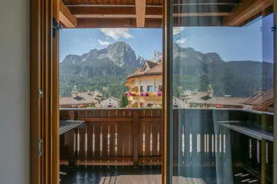 a balcony with a view of a mountain at Mountain Vibes Colfosco in Colfosco
