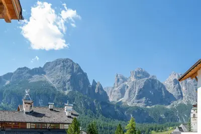 a mountain view of a town with houses and mountains at Mountain Vibes Colfosco in Colfosco