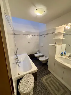 a bathroom with a tub and a sink and a toilet at Pragma Apartments - Casa Defrancesco in Cavalese