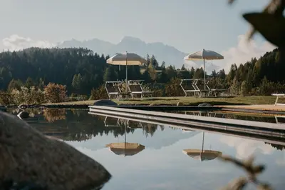 a ski lodge with a view of a mountain at Green Luxury Hotel Pfösl in Nova Ponente