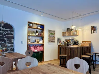 a restaurant with tables and chairs and a counter at Berg Apartment Vajolet - Unterweger Berg Apartments in Tisens