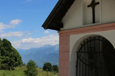 a building with a door with a cross on top at Berg Apartment Vajolet - Unterweger Berg Apartments in Tisens