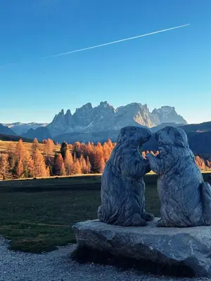 a statue of two bears sitting on a rock at Suite Chalet Stella Margherita in Passo San Pellegrino