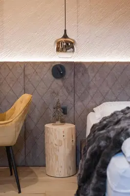 a bedroom with a bed and a table and a chair at Suite Chalet Stella Margherita in Passo San Pellegrino