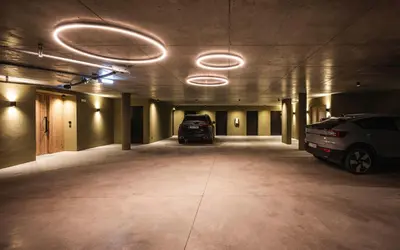 an empty parking garage with two cars parked in it at Florisa Mountain Chalet in Tires