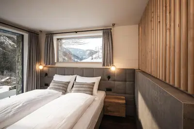 two beds in a room with a window at Florisa Mountain Chalet in Tires