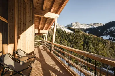 a balcony of a cabin with a view of the mountains at Florisa Mountain Chalet in Tires