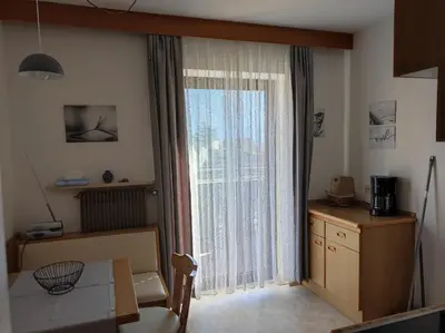 a room with a large window with a table and a desk at Apartment Kapplerhof in Lana