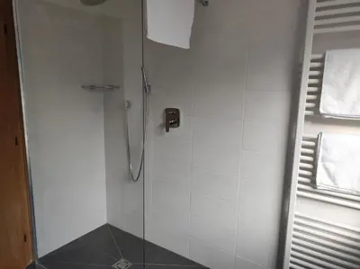 a bathroom with a shower with a glass door at Apartment Kapplerhof in Lana