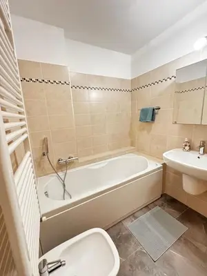 a bathroom with a tub and a toilet and a sink at Appartamento La Finestra sul Pelmo in San Vito di Cadore