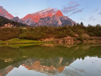 a reflection of a mountain in a lake at Appartamento La Finestra sul Pelmo in San Vito di Cadore