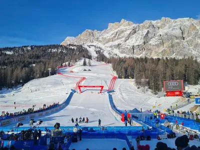 a group of people skiing down a ski slope at Appartamento La Finestra sul Pelmo in San Vito di Cadore