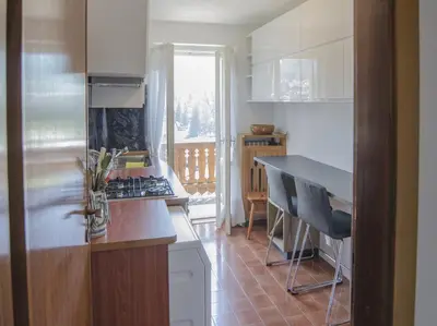 a kitchen with a stove and a counter top at Casa Ronco in Cortina dʼAmpezzo