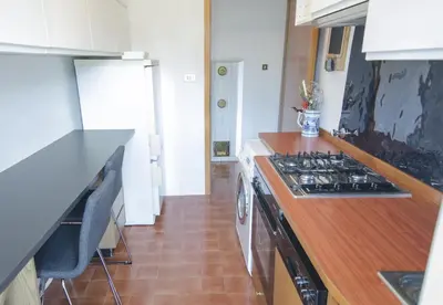 a kitchen with a stove and a counter top at Casa Ronco in Cortina dʼAmpezzo
