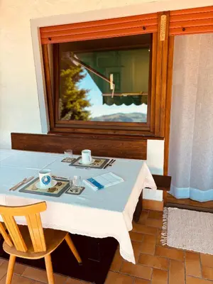 a table in a room with a table and a window at Apartment Fiemme Valley in Carano