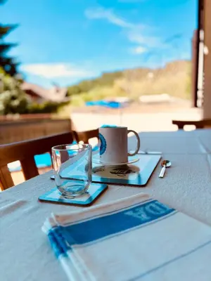 a table with a cup and a glass on it at Apartment Fiemme Valley in Carano