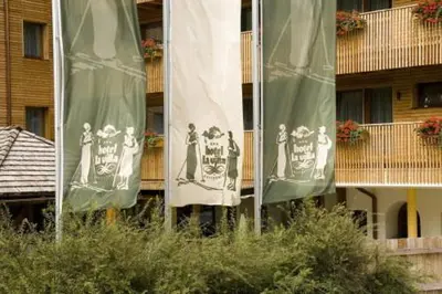 a group of flags in front of a building at Residence La Villa in La Villa