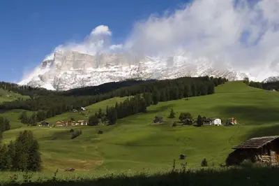 a green field with a mountain in the background at Residence La Villa in La Villa