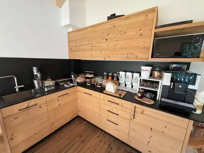 a kitchen with wooden cabinets and a microwave at Fiemme in Vista in Ziano di Fiemme
