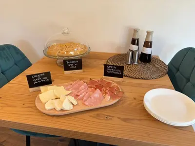 a table with a plate of food and bottles of wine at Fiemme in Vista in Ziano di Fiemme