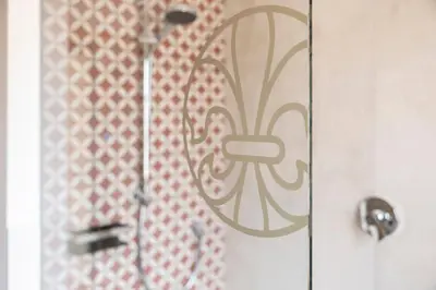 a shower with a design on the door at Essa Suites - NEW in Caldaro