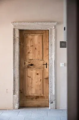 a wooden door in the corner of a room at Essa Suites - NEW in Caldaro