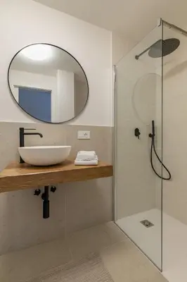 a bathroom with a sink and a mirror at REMO 4 by WelcHome in San Vito di Cadore