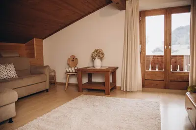 a living room with a couch and a table at Farm apartment I neni in Lovara