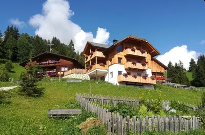 a house on top of a hill with a fence at Farm apartment I neni in Lovara