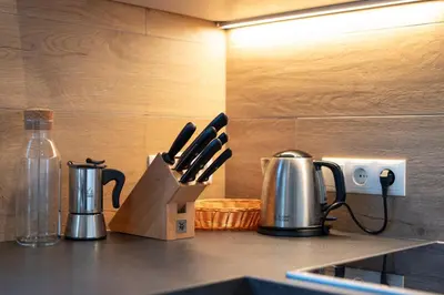 a kitchen counter with two utensils and a knife block at Langegger 1956 in Bolzano