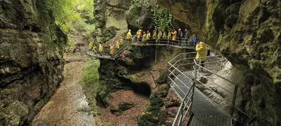 a group of people on a suspension bridge in a canyon at Casanna in Cavareno