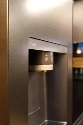 a stainless steel refrigerator with the word trico on it at Leos Chalet in Valdaora di Sopra