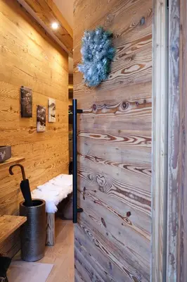 a room with a wooden wall with a door at Leos Chalet in Valdaora di Sopra